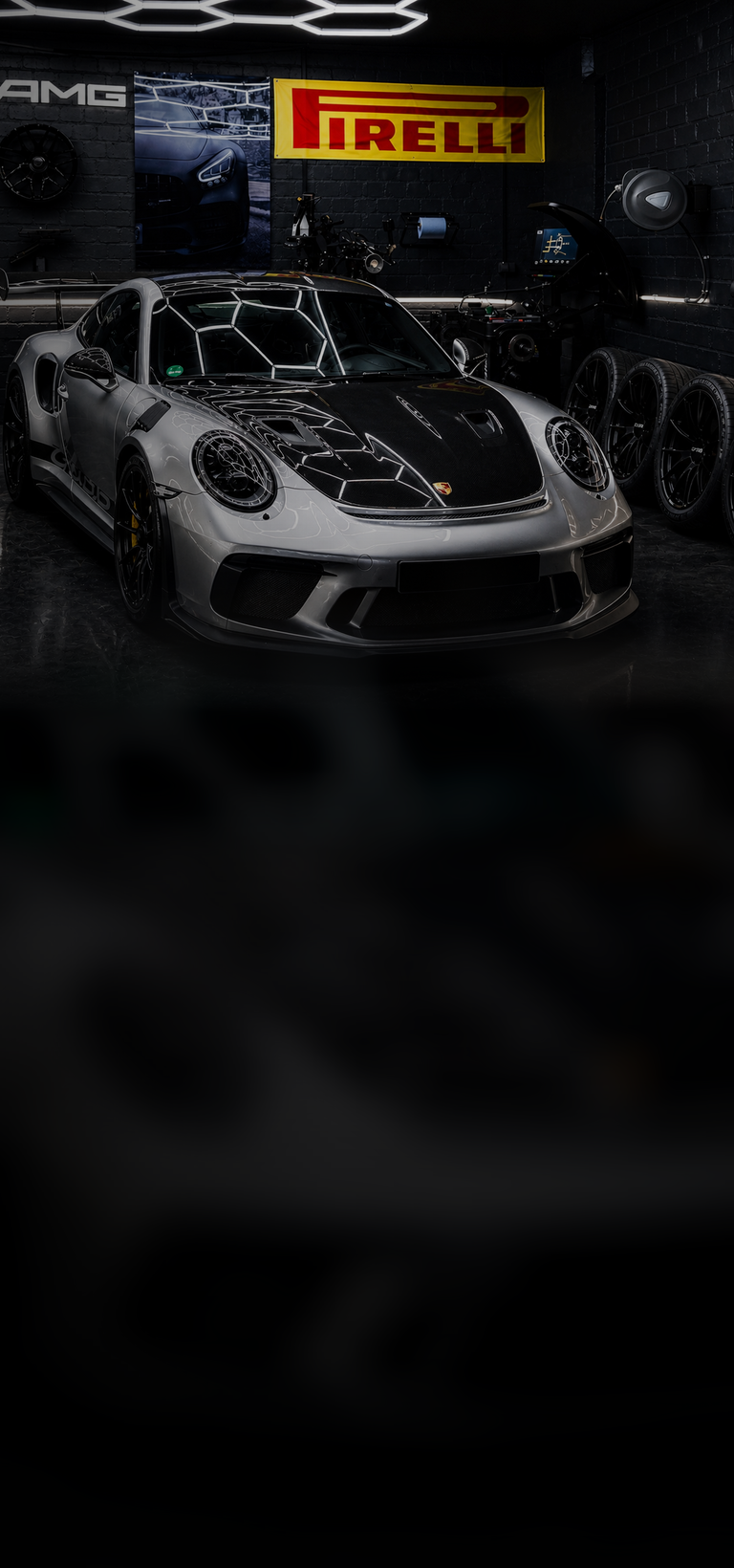 Premium vehicle in a dark tire and workshop bay